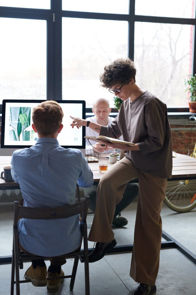 A group of colleagues discussing a project in a modern office environment.